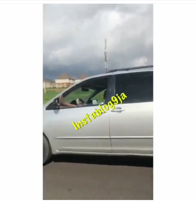 Man places his leg on the window, as he smokes while driving on an expressway in Abuja…