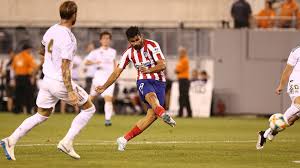 Diego Costa scored four goals as Atletico Madrid humiliated LaLiga rivals Real Madrid 7-3 in an incredible display at the International Champions Cup. Atletico showed no mercy in New Jersey, where Diego Simeone’s men led 5-0 at half-time thanks to Costa’s first-half hat-trick on Friday. Big-money signing Joao Felix scored his first goal since arriving from Benfica and set up two others, while Angel Correa was also on target in a sensationally one-sided first half at MetLife Stadium. Costa teamed up with Joao Felix to add his fourth six minutes into the second half before he was sent off after clashing with Dani Carvajal, which sparked a melee. Vitolo scored a sensational solo goal in the 70th minute after Nacho Fernandez reduced the deficit on the hour-mark, while Madrid substitute Karim Benzema converted an 85th-minute penalty and Javi Hernandez bundled the ball over the line late. Atletico were ruthless from the outset, last season’s runners-up breaking the deadlock after just 43 seconds when Joao Felix played a neat pass to Costa, whose deflected shot beat Thibaut Courtois. That was a sign of things to come as Joao Felix made it 2-0 less than seven minutes later – the former Benfica teenager stepping in front of Marcelo and side-footing from close range after Saul Niguez cut a pass back into the penalty area. After a lively Alvaro Morata left the field due to an apparent calf injury, his replacement Correa – linked to AC Milan – put Atletico 3-0 ahead in the 19th minute with a volley past Courtois. While Joao Felix and Costa continued to wreak havoc, Madrid’s woes were compounded by what appeared to be a knee injury to new signing Luka Jovic, who had to be substituted following a collision with Atletico goalkeeper Jan Oblak. Madrid’s defensive problems were highlighted again as Atletico went 4-0 ahead in the 28th minute – Saul winning the ball after a bad pass from Ramos and sliding in a simple pass for Costa and he made no mistake. Hermoso and Thomas Lemar also went close, while Vinicius Junior hit the post for Madrid. But Atletico netted their fourth on the stroke of half-time after Costa completed his hat-trick from the penalty spot following Isco’s foul. Atletico did not take their foot off the pedal in the second half – Felix and Costa continuing their frightening combination as the former split Madrid’s defence with a delightful pass and the former scooped the ball over Keylor Navas in the 51st minute. Eden Hazard was virtually non-existent in first half, but the Belgian star showed a flash of brilliance to help Madrid pull a goal back on the hour-mark, crossing the ball into the six-yard box for Nacho to bundle the ball over the line. There was a flashpoint five minutes later when Costa and Carvajal were both sent off after the pair and both teams came together as tempers threatened to boil over. It got worse for Madrid after Vitolo won the ball from two defenders on the half-way line and beat another two opponents before finding the back of the net following a stunning solo run with 20 minutes remaining. Atletico were hungry for more and they should have scored another two or three goals but some desperate goalkeeping and defending denied Los Rojiblancos, while Benzema and Hernandez added goals for Madrid late in the game. Source:- SoccerNews