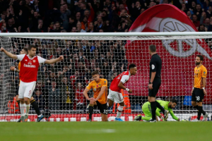 Pierre-Emerick Aubameyang scores his 50th Arsenal goal as Wolves come from behind to held Gunners 1-1 in the Premier League encounter at Emirate Stadium on Saturday evening. Gabon international handed the armband in Granit Xhaka’s absence while crowd-favourite Mesut Ozil was restored to the line-up, the Gunners were far from convincing.Arsenal’s greater quality in the final third had given them the edge at the interval when Alexandre Lacazette showed great composure to feed Aubameyang for the opener.Lacazette collected David Luiz’s deflected cross and squared for his strike partner to slot the ball beyond Rui Patricio. The Gunners missed a great chance to double the lead minutes later as Conor Coady and Leander Dendoncker made a mess of dealing with Callum Chambers’ cross, but Torreira could only shoot straight at Rui Patricio.The visitors began the second half as they had the first, putting Arsenal under pressure, and the anxiety was tangible around the Emirates, particularly whenever the ball was at Leno’s feet.But it was Arsenal’s defensive frailties that would eventually show once more, as they were caught napping by a quick throw-in and Jimenez got up between Chambers and Sokratis to head home.