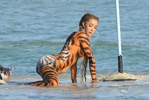 Did we see a pussy- cat? We thought we saw a pussy- cat! Oh, no it is Cardi B, with full body paint, dancing and twerking on the beach, showing that big, round ass and hot cameltoe to everyone and obviously having tons of fun with friends.