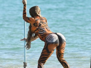 Did we see a pussy- cat? We thought we saw a pussy- cat! Oh, no it is Cardi B, with full body paint, dancing and twerking on the beach, showing that big, round ass and hot cameltoe to everyone and obviously having tons of fun with friends.