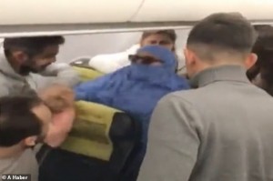 A woman claiming to be a terrorist sparked panic on board a flight from Istanbul today after angrily waving a Koran in the cabin and threatening to blow up the plane. 