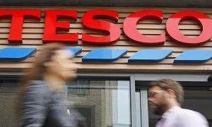 Tesco sees profits halve to £1bn as costs rise