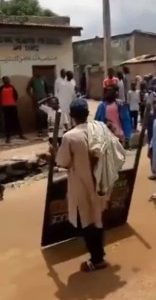 Man Captured Looting Police Signpost In Northern Nigeria (Photos)