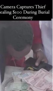 Thief captured on video stealing $100 during a burial ceremony