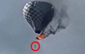 Horror at balloon festival as man falls to his death from burning hot air balloon (video)